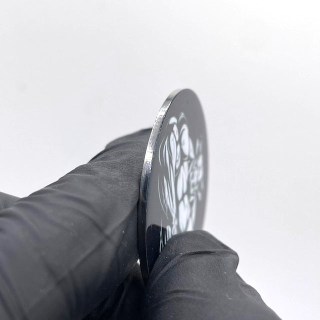 A close up view of the side of a stainless steel barbell end caps. The  picture gives you an idea of how thick the stainless steel end cap is.