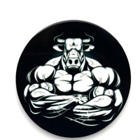 A close up view of the front  of a bull strength barbell end caps.