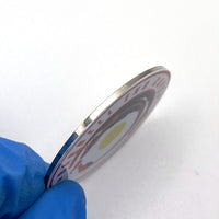 A close up view of the side of a stainless steel barbell end caps. The  picture gives you an idea of how thick the stainless steel end cap is.